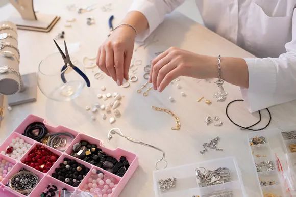 designer making handmade jewelry in studio