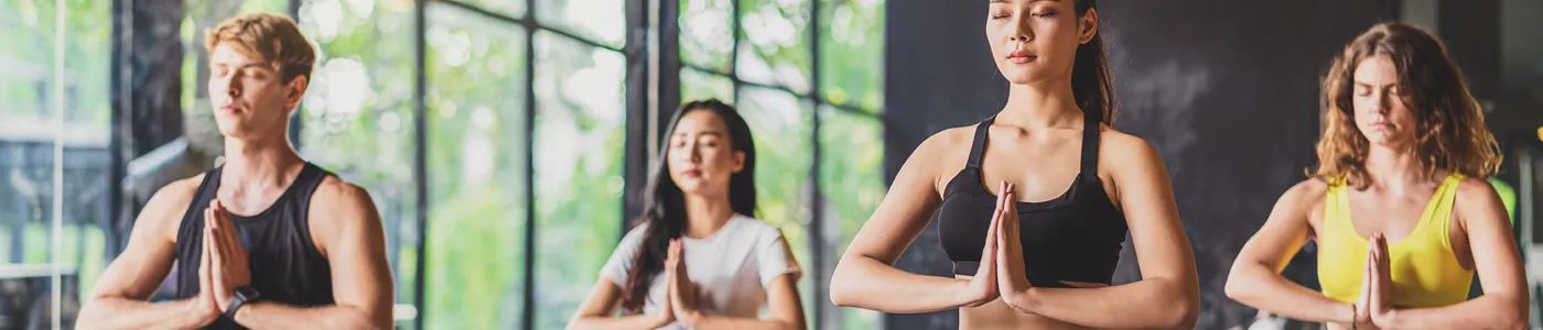 Group of diversity practicing yoga class