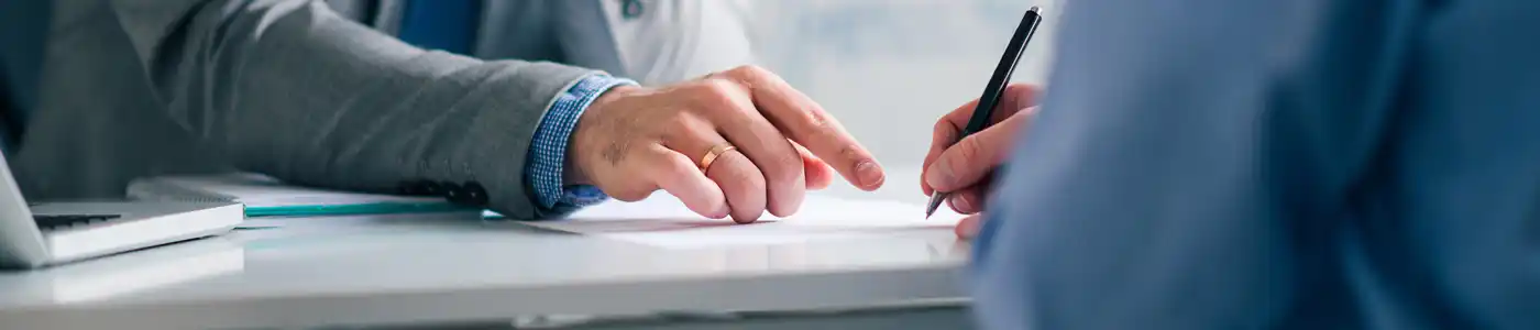 Image of two men and signing agreement