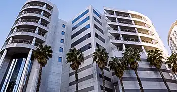 A bottom view of three skyscrapers